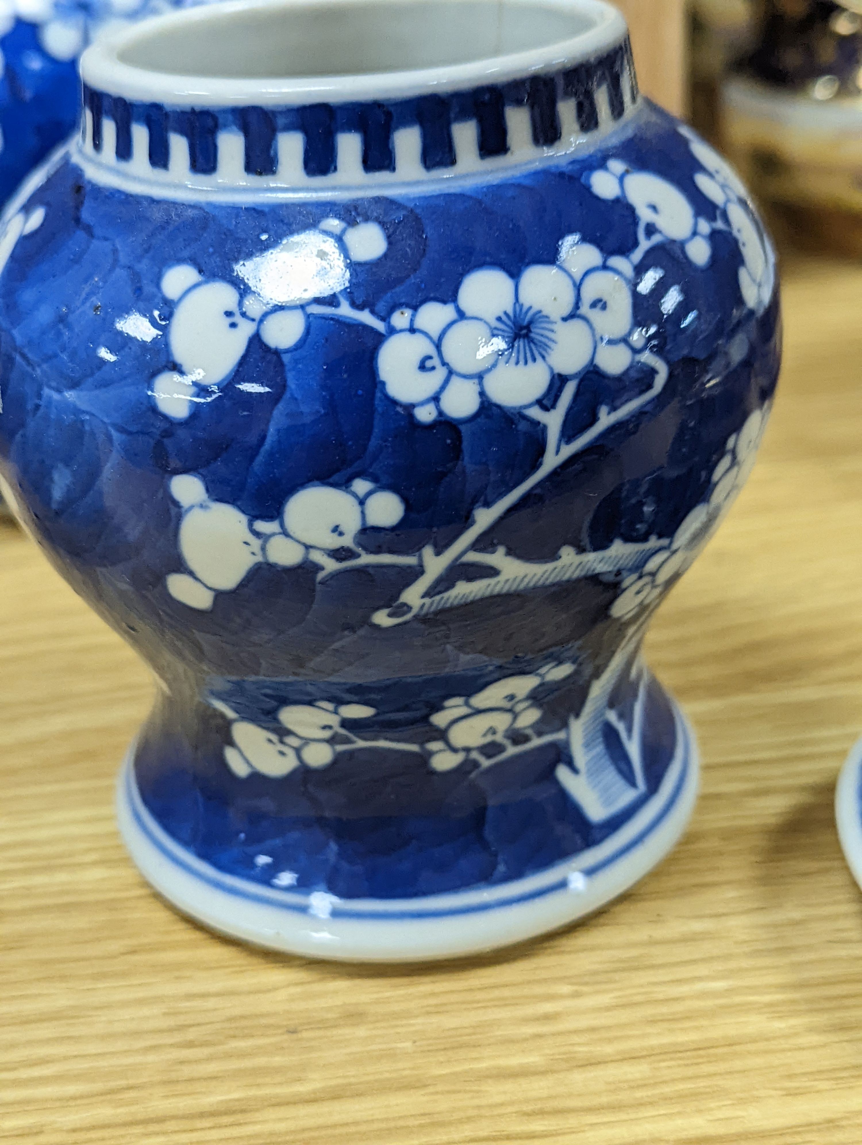 Three Chinese blue and white prunus decorated jars and covers, 19th/20th century, with four character marks 18cm